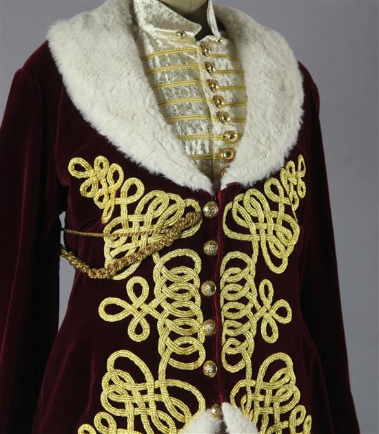 Fledermaus: Prince Orlofskys maroon velvet jacket, trimmed with gold braid and white fur trim, a matching silver and gold waistcoat an